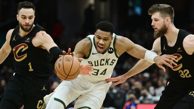 Dec 29, 2023; Cleveland, Ohio, USA; Cleveland Cavaliers guard Max Strus (1) and forward Dean Wade (32) and Milwaukee Bucks forward Giannis Antetokounmpo (34) go for a loose ball during the second half at Rocket Mortgage FieldHouse.
